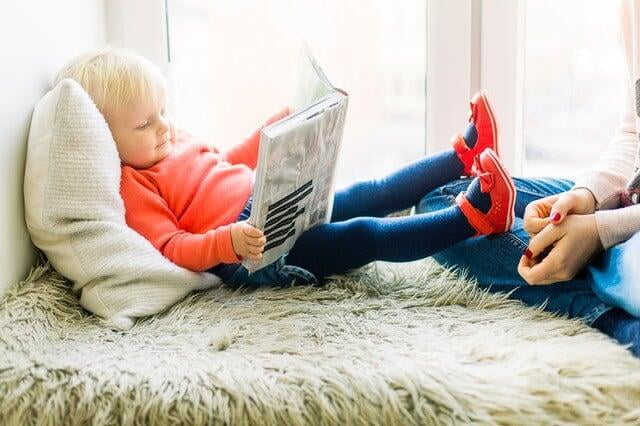 White baby reading a book. Ad for Chinese language class.